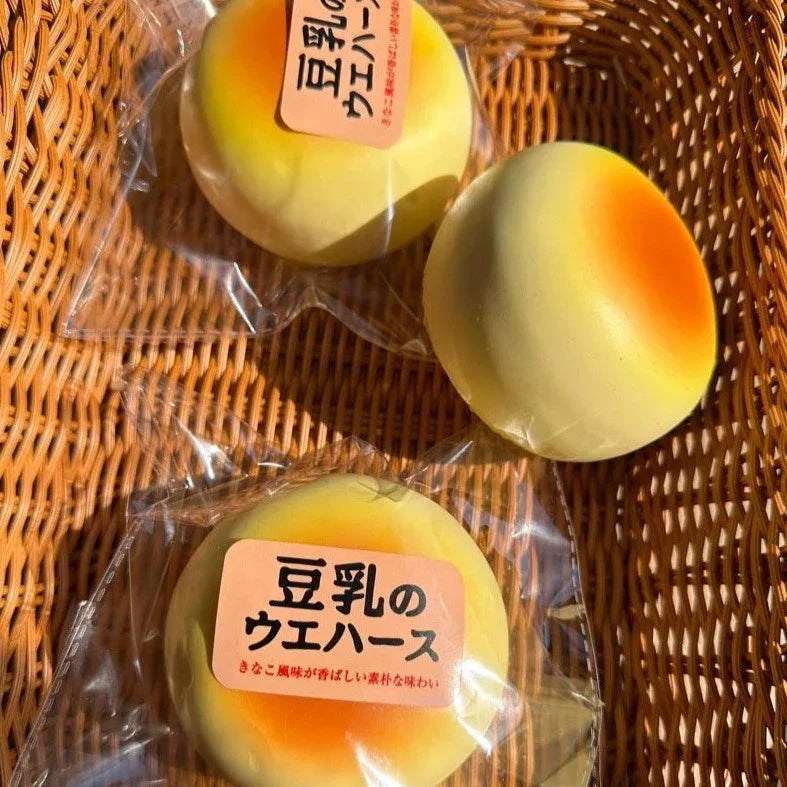 Round Bread Bun Slow-Rising Squishy – Pale Yellow Bakery-Inspired Dome with a Golden Orange Top and Smooth Rounded Shape