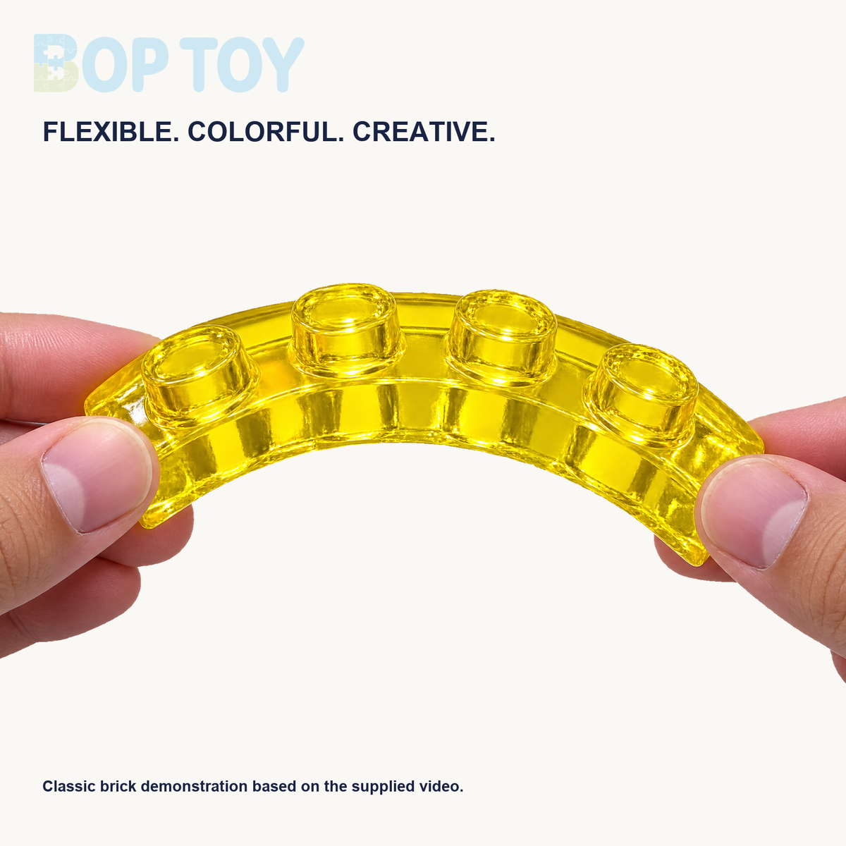 Video-reference demonstration of hands bending a translucent yellow classic four-stud jelly brick