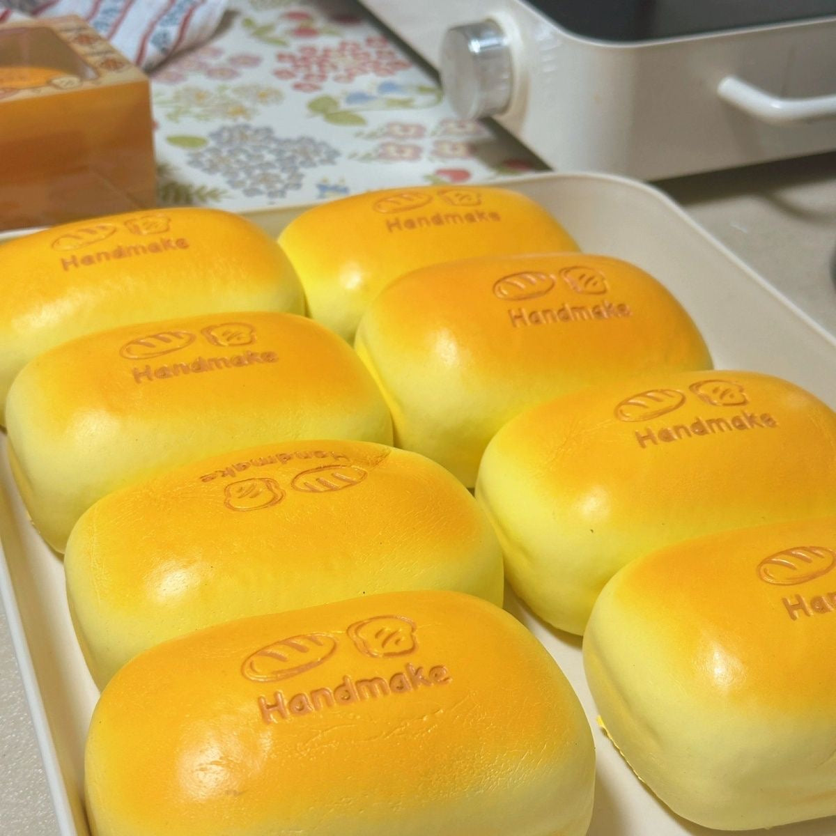Golden Bread Loaf Slow-Rising Squishy – Rounded Rectangular Bun with Embossed Handmake Lettering and Two Bread Icons