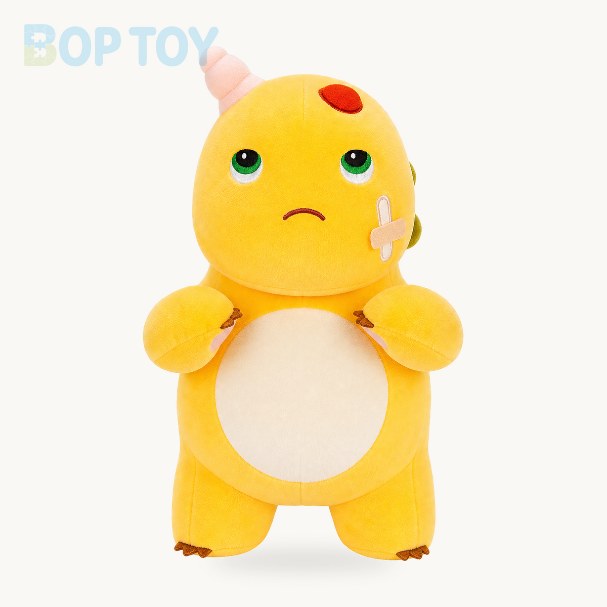 Funny bandaged yellow dinosaur plush, full front view