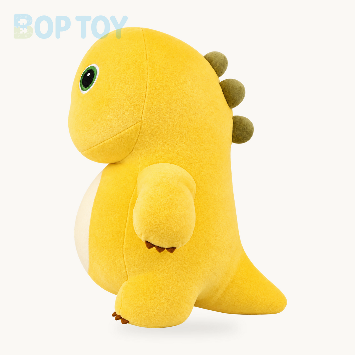 Yellow dinosaur plush toy, side view showing tail and three back spikes