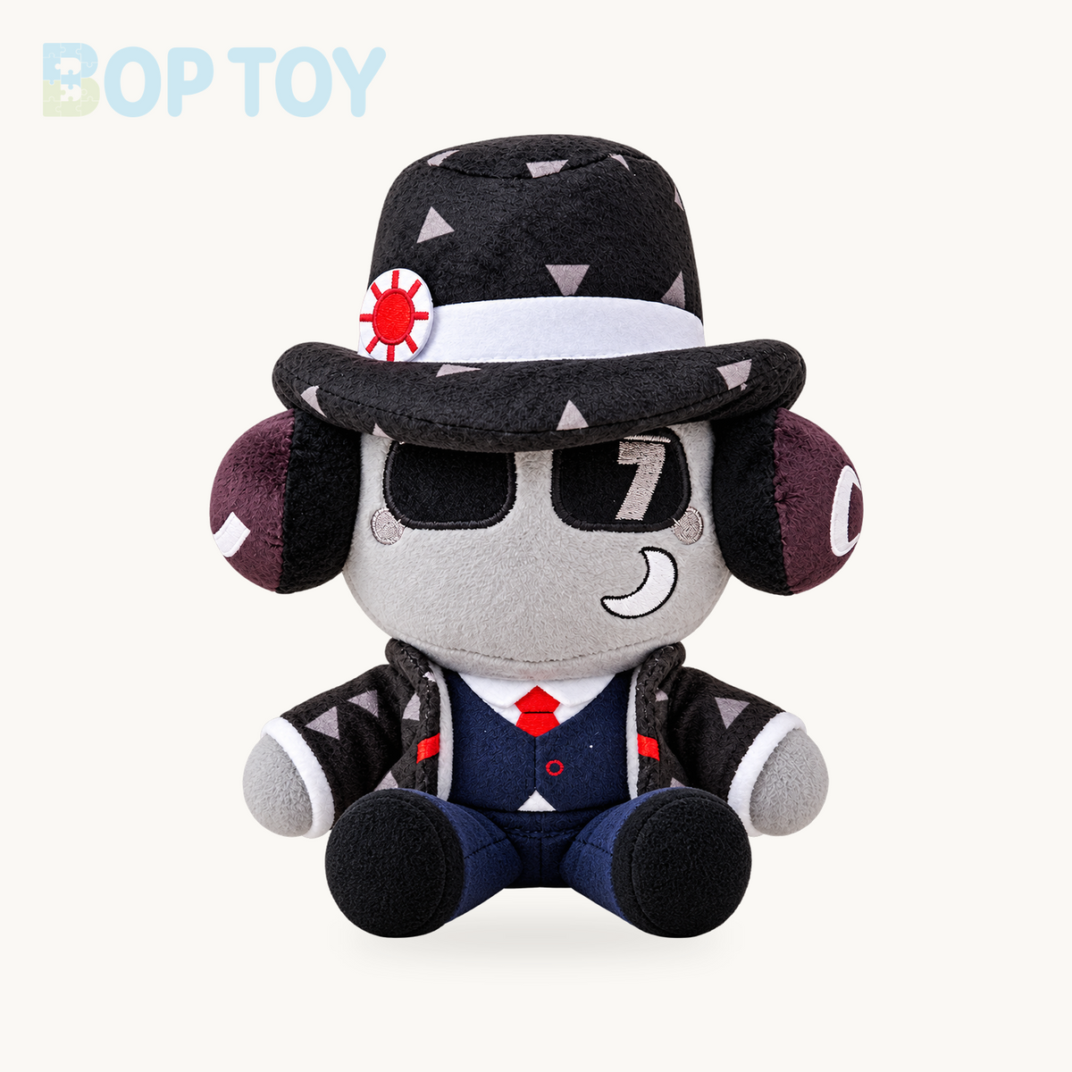 Patterned fedora character plush in seated pose on a cream background