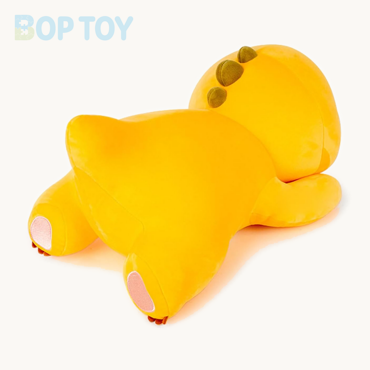 Lying yellow dinosaur plush toy rear view and feet