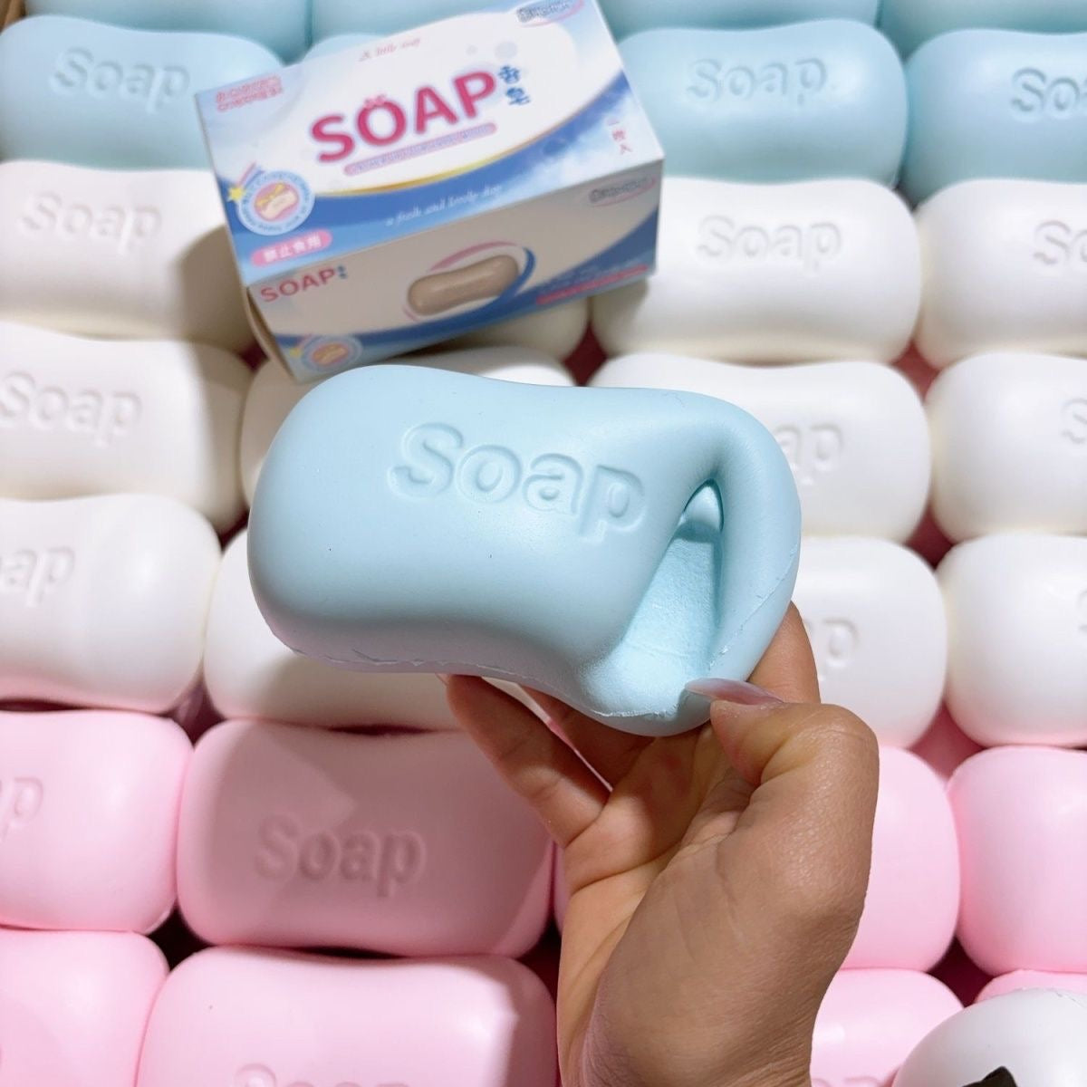 Soap Bar Slow-Rising Squishy – Rounded Squeeze Toy with Molded Soap Lettering in White, Pink or Blue