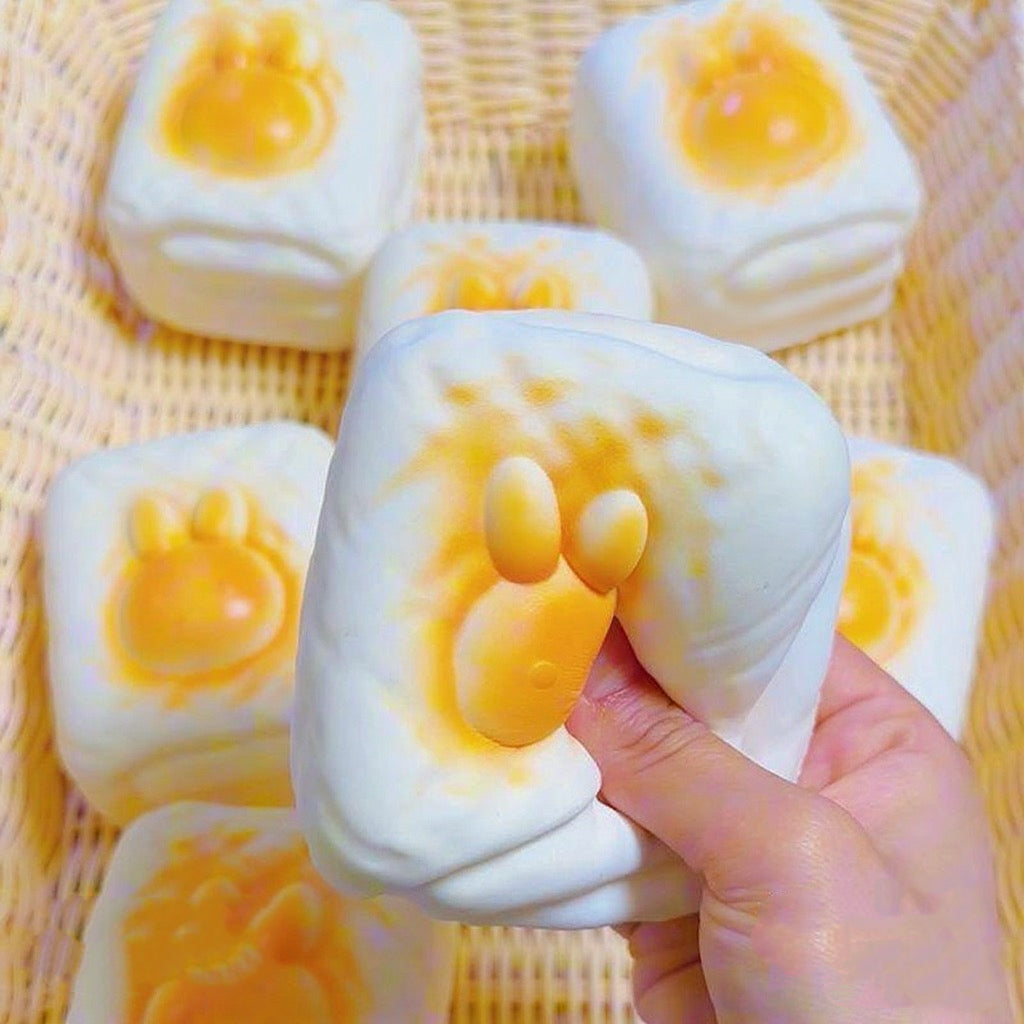 Bunny Toast Slow-Rising Squishy – Creamy White Rounded Block with a Raised Golden Rabbit Face and Side Grooves