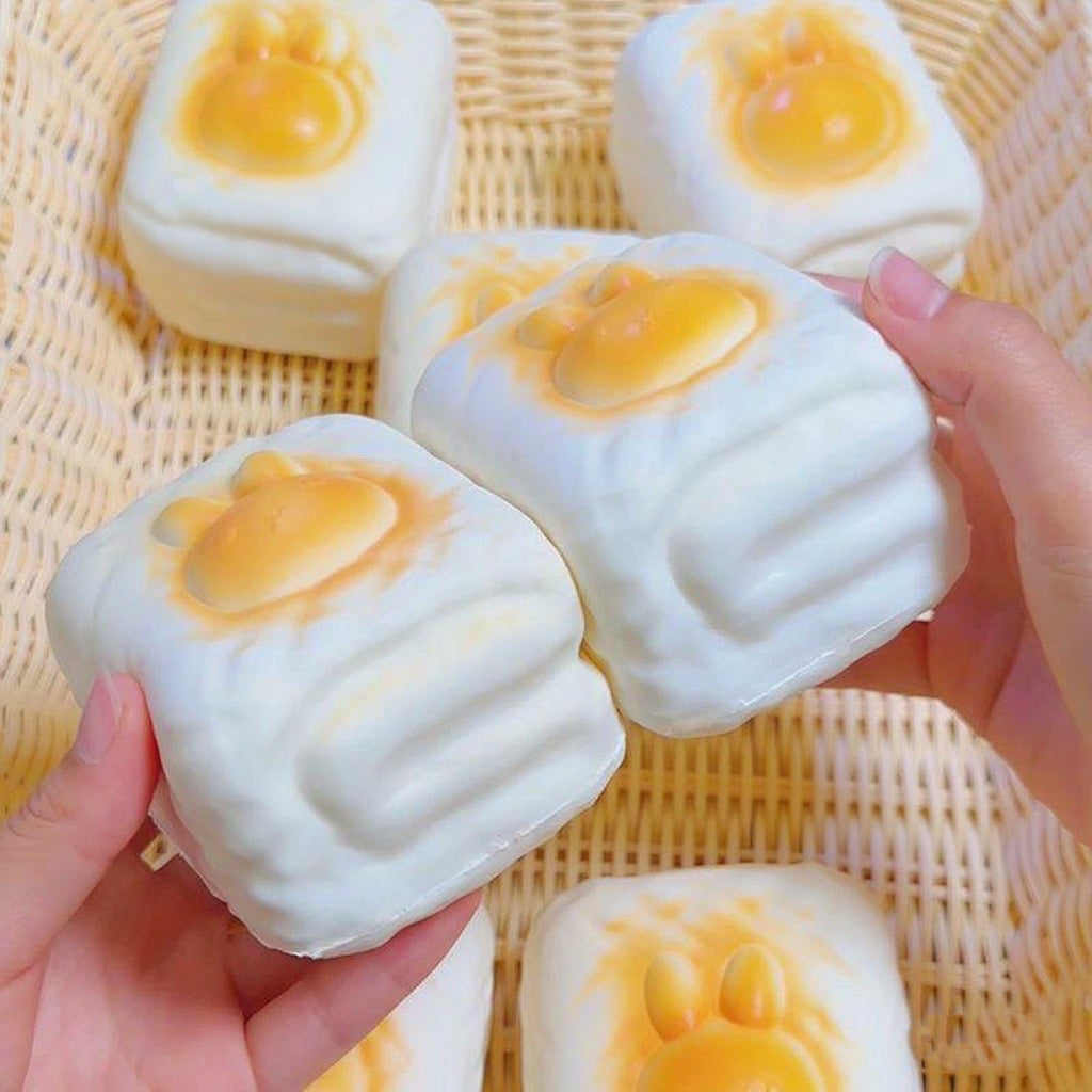 Bunny Toast Slow-Rising Squishy – Creamy White Rounded Block with a Raised Golden Rabbit Face and Side Grooves