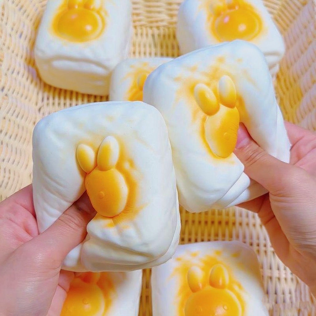 Bunny Toast Slow-Rising Squishy – Creamy White Rounded Block with a Raised Golden Rabbit Face and Side Grooves
