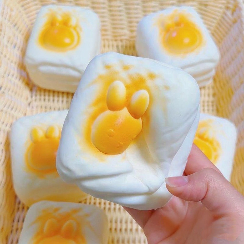 Bunny Toast Slow-Rising Squishy – Creamy White Rounded Block with a Raised Golden Rabbit Face and Side Grooves