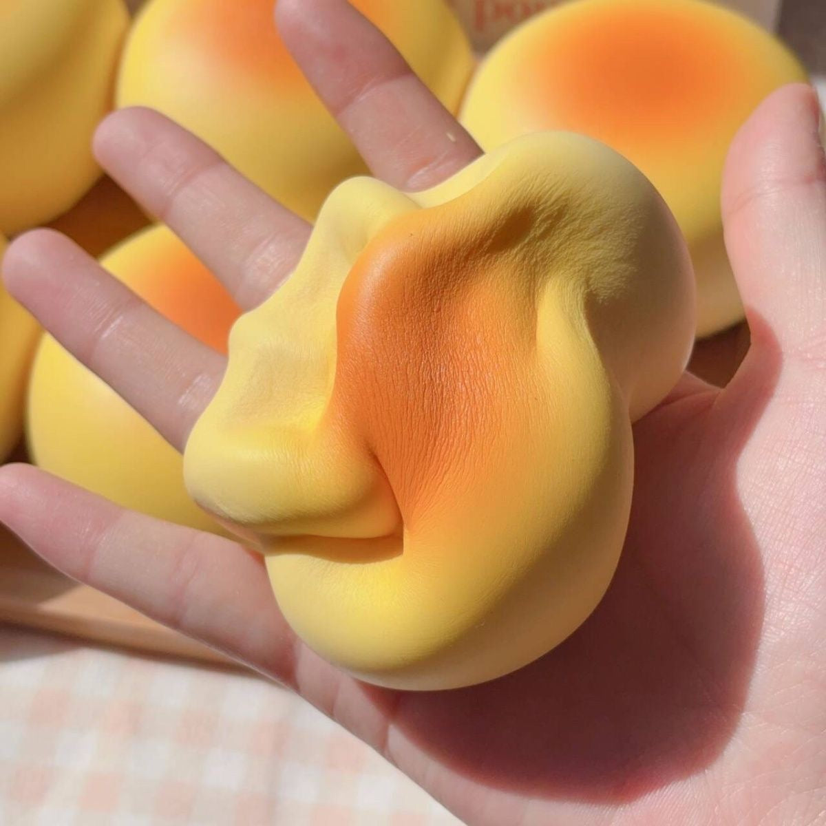 Round Bread Bun Slow-Rising Squishy – Pale Yellow Bakery-Inspired Dome with a Golden Orange Top and Smooth Rounded Shape