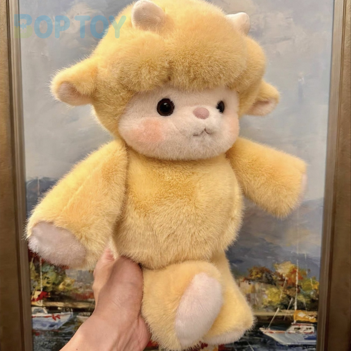 Puff golden yellow lamb plush, actual three-quarter photograph held in hand