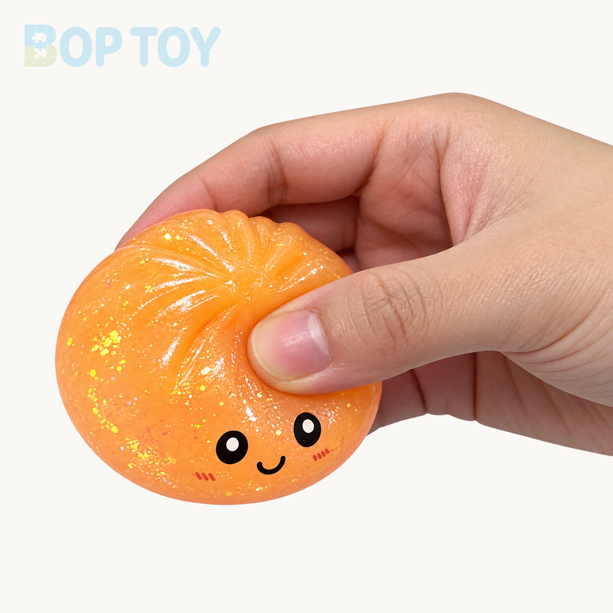 Orange glitter bun with gentle thumb pressure