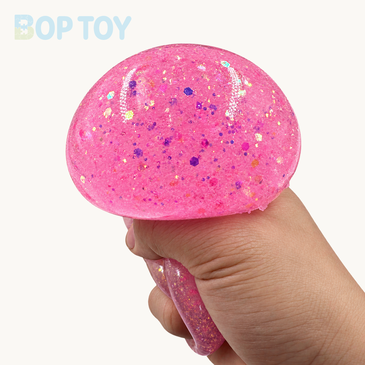 Pink glow bun squeezed in hand - original deformation retained