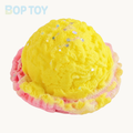 Yellow ice cream scoop squishy toy on BOPTOY cream background