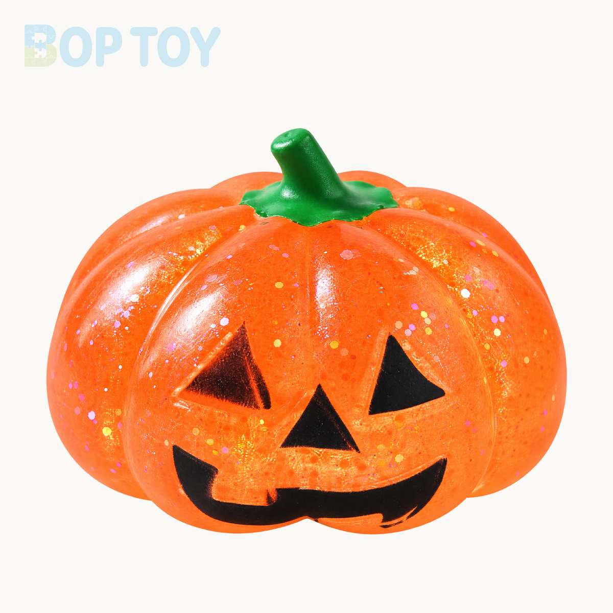 Orange glitter pumpkin squishy with green stem and black jack-o-lantern face; packaging depends on selected option