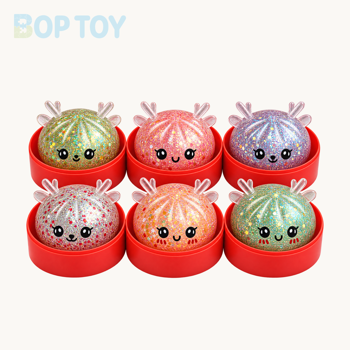 Six Christmas glitter reindeer bun squishy color and face examples with red steamers; single variant contains one randomly selected toy