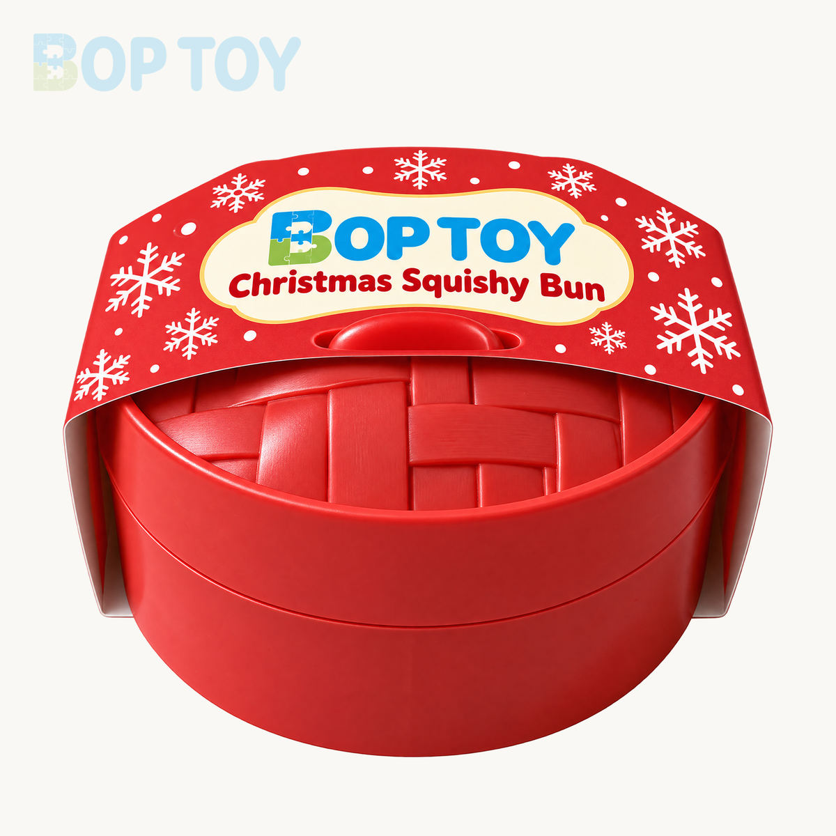 Red lidded plastic steamer with woven pattern and BopToy printed Christmas paper belly band