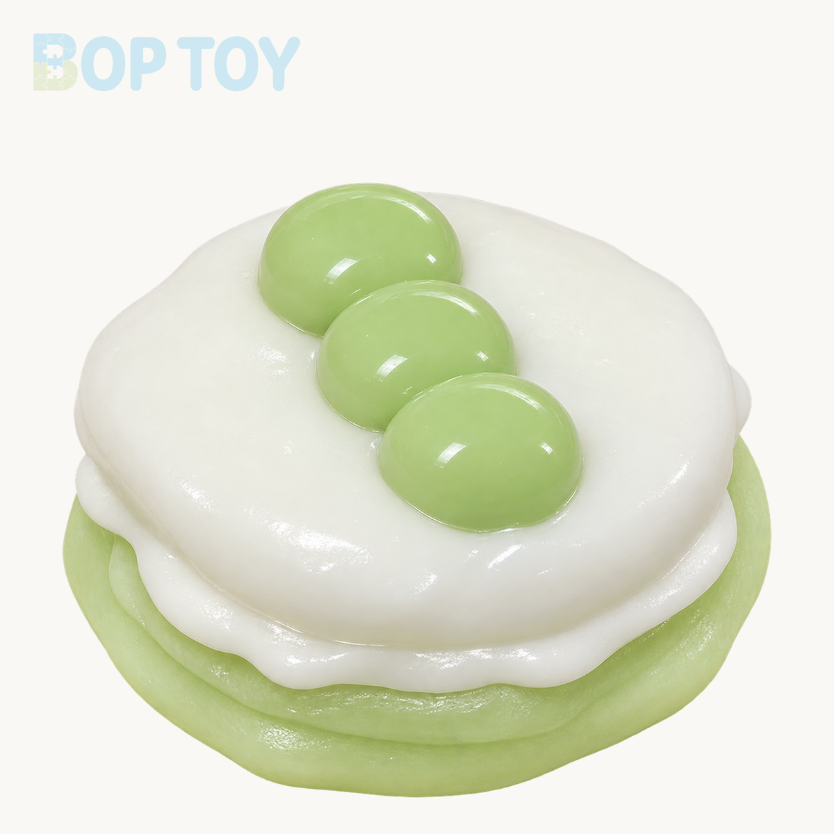green handmade silicone souffle cake squishy on BOPTOY cream background