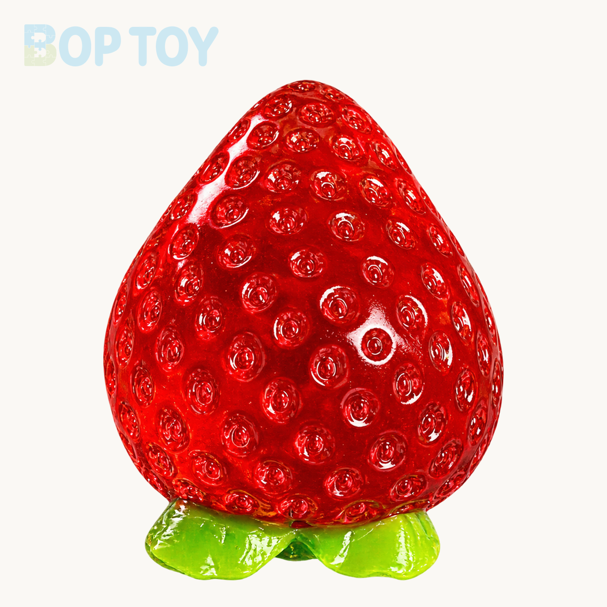One transparent red strawberry Taba squishy toy on BOPTOY cream background