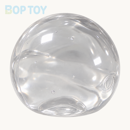 One clear transparent soft stress ball on BOP TOY cream background, no hand