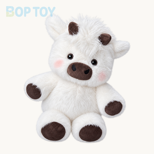 Cream fluffy Highland calf plush on a warm ivory background