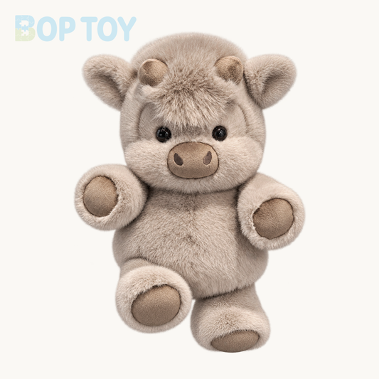 Grey Bean fluffy Highland calf plush on a warm ivory background