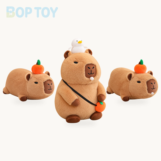 Fluffy Sleepy Capybara with Orange Plushie product selection on a cream background